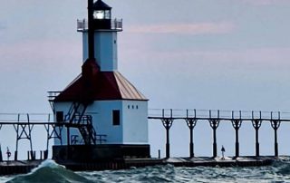 A photo of two unusually shaped lighthouses connected by what appears to be a pier or walkway.